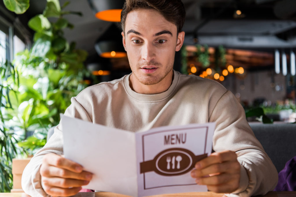 A man overwhelmed by choice reading a menu